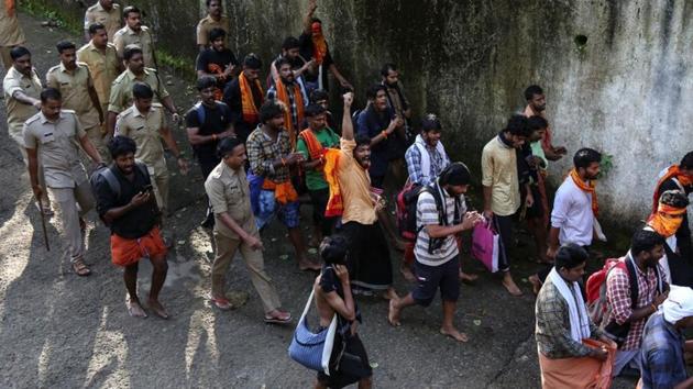 Policemen escort protesters to Pambha base camp to prevent clashes with women and cops attempting to enter the Sabarimala temple, in Pathanamthitta in Kerala, on October 18, 2018. (Reuters) Policemen escort protesters to Pambha base camp to prevent clashes with women and cops attempting to enter the Sabarimala temple, in Pathanamthitta in Kerala, on October 18, 2018. (Reuters)