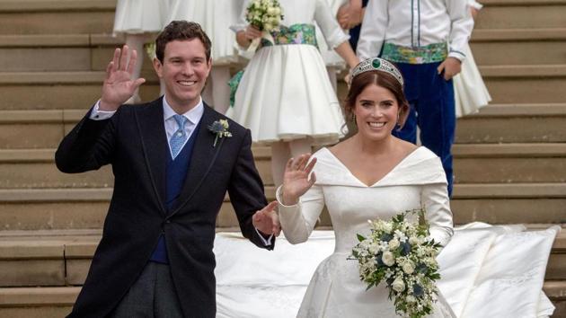 Britain’s Princess Eugenie of York (R) and her husband Jack Brooksbank wave as they emerge from the West Door of St George’s Chapel, Windsor Castle, England. (Steve Parsons / Pool / AFP)