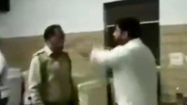A screengrab from a video shows BJP municipal councillor Manish Panwar arguing with a police officer in his restaurant before beating him up, in Meerut.(ANI/Twitter)