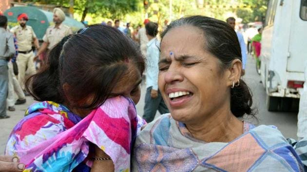 Relatives of those killed during the train accident mourn as they wait for the dead bodies outside the mortuary at Amritsar Civil Hospital on Saturday. (sameer sehgal)
