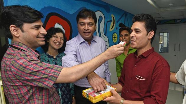 Doctors give sweets to Hitesh Valand, husband of Minaxi Valand (patient), after Minaxi gave birth to a baby girl at Galaxy hospital on Karve road in Pune (Pratham Gokhale/HT Photo) Doctors give sweets to Hitesh Valand, husband of Minaxi Valand (patient), after Minaxi gave birth to a baby girl at Galaxy hospital on Karve road in Pune (Pratham Gokhale/HT Photo)