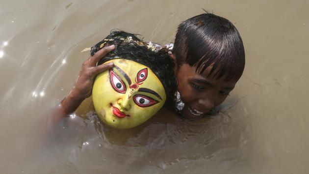 A boy carries the head of an idol of Hindu goddess Durga after its immersion into the waters of the river Howrah on the last day of the Durga Puja festival in Agartala, Tripura. (Jayanta Dey / REUTERS) A boy carries the head of an idol of Hindu goddess Durga after its immersion into the waters of the river Howrah on the last day of the Durga Puja festival in Agartala, Tripura. (Jayanta Dey / REUTERS)