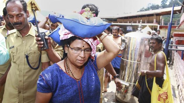 A female devotee who had trekked up with her family to Sabarimala temple, in Pathanamthitta, Saturday, Oct 20, 2018. (PTI) A female devotee who had trekked up with her family to Sabarimala temple, in Pathanamthitta, Saturday, Oct 20, 2018. (PTI)