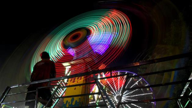 A Ferris wheel lit up during the Dussehra fair at Ramlila ground near Red Fort in New Delhi. (Amal KS / HT Photo) A Ferris wheel lit up during the Dussehra fair at Ramlila ground near Red Fort in New Delhi. (Amal KS / HT Photo)