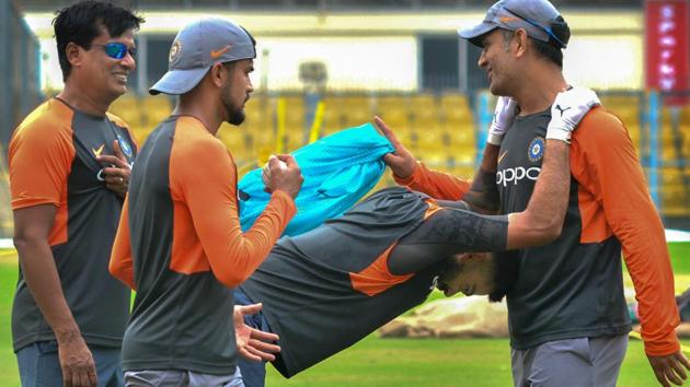 Team India captain Virat Kohli and MS Dhoni (R) share a light moment during a practice session ahead of the first One Day International cricket match against West Indies, at ACA Cricket Stadium, Barsapara in Guwahati, Assam. (PTI) Team India captain Virat Kohli and MS Dhoni (R) share a light moment during a practice session ahead of the first One Day International cricket match against West Indies, at ACA Cricket Stadium, Barsapara in Guwahati, Assam. (PTI)