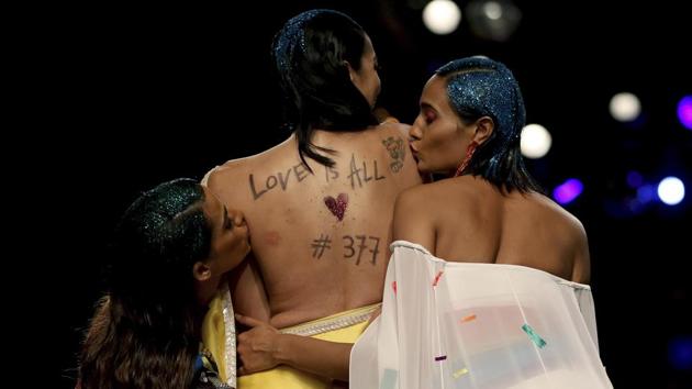 Models kiss the back of another model with a message during the grand finale of Lotus Make-up India Fashion Week based on ‘Rainbow’ theme, an emblem for the LGBTQ community, in New Delhi. (Altaf Qadri / AP) Models kiss the back of another model with a message during the grand finale of Lotus Make-up India Fashion Week based on ‘Rainbow’ theme, an emblem for the LGBTQ community, in New Delhi. (Altaf Qadri / AP)