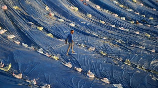 A labourer walks on a temporary pond on the bank of the river Ganga using plastic sheeting, into which idols of the Hindu Goddess Durga will be immersed after ‘Durga Puja’ as part of the ‘Navaratri’ festival, in Allahabad, Uttar Pradesh. (Sanjay Kanojia / AFP) A labourer walks on a temporary pond on the bank of the river Ganga using plastic sheeting, into which idols of the Hindu Goddess Durga will be immersed after ‘Durga Puja’ as part of the ‘Navaratri’ festival, in Allahabad, Uttar Pradesh. (Sanjay Kanojia / AFP)