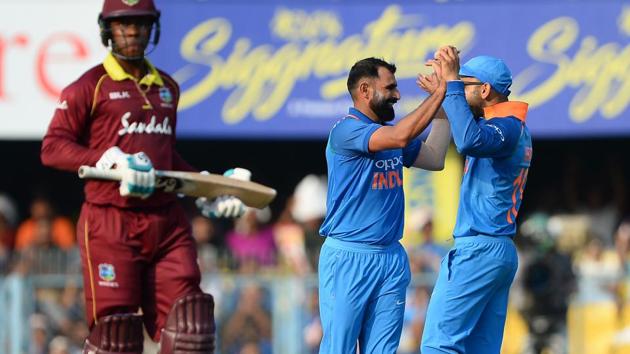Indian bowler Mohammad Shami (C) celebrates with team captain Virat Kohli (R) after he dismissed West Indies batsman. (AFP)