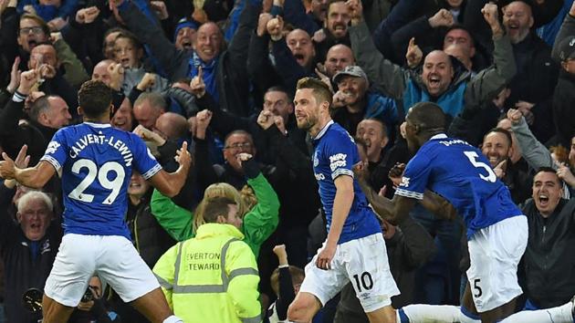 Everton's English striker Dominic Calvert-Lewin (L) celebrates with teammates after scoring the opening goal of the English Premier League football match between Everton and Crystal Palace.(AFP)