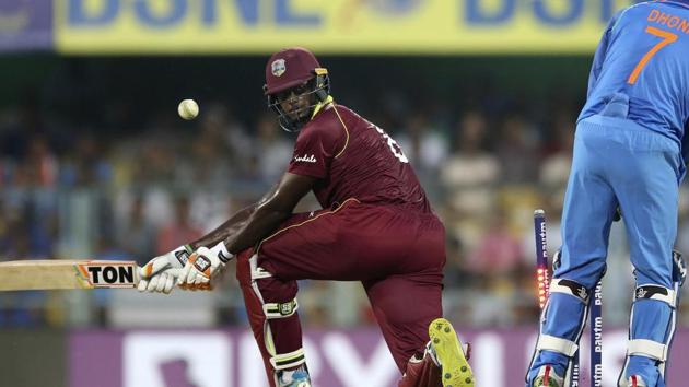 West Indies' batsman Jason Holder, left, looks back as he is bowled out by India's Yuzvendra Chahal. (AP)
