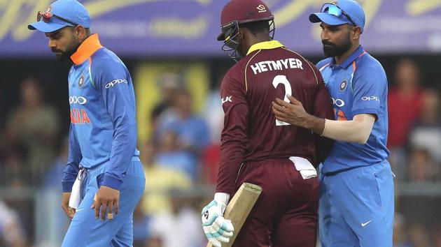 India's Mohammed Shami, right, pats West Indies' batsman Shimron Hetmyer, center, as Hetmyer leaves the field after his dismissal. (AP)