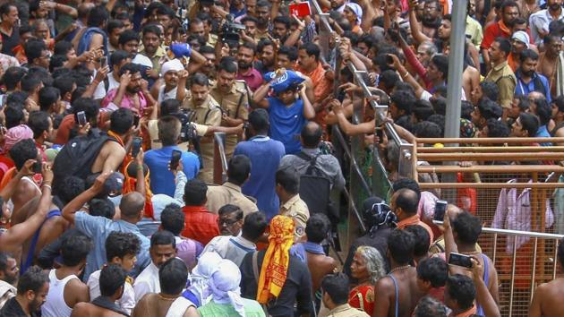 Protestors gather after a lady devotee trekked up with her family to Sabarimala temple, in Pathanamthitta, on October 20, 2018. Two women who reached the hilltop with a heavy police escort, had to turn back before reaching the sanctum sanctorum following protests by temple devotees. (PTI) Protestors gather after a lady devotee trekked up with her family to Sabarimala temple, in Pathanamthitta, on October 20, 2018. Two women who reached the hilltop with a heavy police escort, had to turn back before reaching the sanctum sanctorum following protests by temple devotees. (PTI)