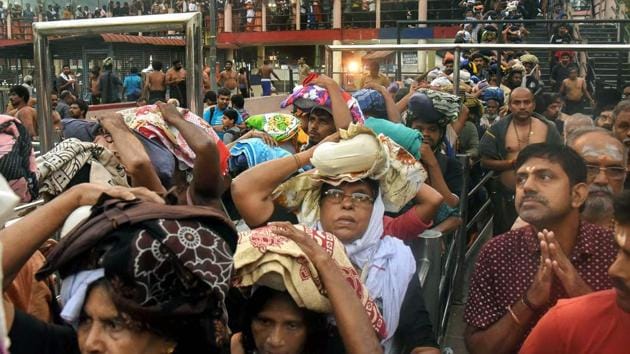 Devotees arrive to pay obeisance at Lord Ayyappa Temple in Sabarimala even as protesters keep women aged between 10 and 50 away despite the Supreme Court order.(PTI Photo)