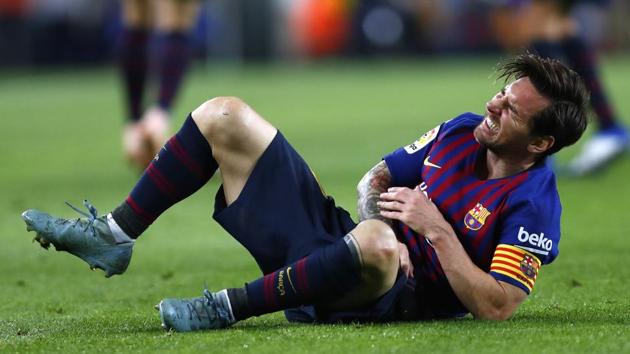 Lionel Messi reacts after fracturing his arm in the match between FC Barcelona and Sevilla at the Camp Nou Stadium in Barcelona. (AP) Lionel Messi reacts after fracturing his arm in the match between FC Barcelona and Sevilla at the Camp Nou Stadium in Barcelona. (AP)