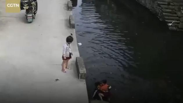 The six-year-old girl was washing a mop in the water when she slipped inside. (CGTN/Twitter) The six-year-old girl was washing a mop in the water when she slipped inside. (CGTN/Twitter)