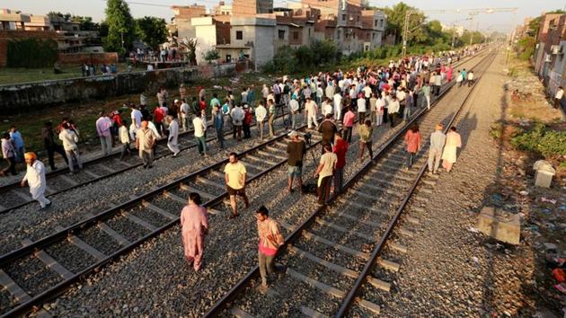 People gather at the site of an accident after a commuter train travelling at high speed ran through a crowd of people on the rail tracks on in Amritsar on October 20. (REUTERS) People gather at the site of an accident after a commuter train travelling at high speed ran through a crowd of people on the rail tracks on in Amritsar on October 20. (REUTERS)