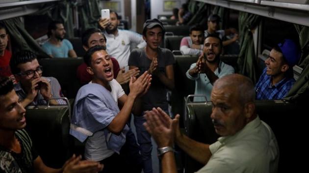 People sing in a train as they travel through the outskirts of Damascus towards the recently opened international fair. Although, the risk of being hit by bullets or shellfire near the capital has now ended, but conditions in central Damascus, with its relaxed nightlife and bustling business district, seem a world away from the hardship of eastern Ghouta. (Marko Djurica / REUTERS)