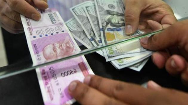 A customer exchanges currency at a forex bureau in New Delhi. (PTI Photo) A customer exchanges currency at a forex bureau in New Delhi. (PTI Photo)