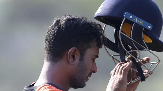 India's Ambati Rayudu prepares to wear a helmet before batting in the nets during a practice session ahead of the second one-day international cricket match between India and West Indies in Visakhapatnam(AP)