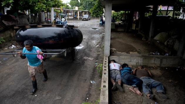 A man carries his raft made out of tractor inner tubes, as Honduran migrants sleep rough on the ground, at the Guatemala-Mexico border. A taper could well happen this time around as some turn back, splinter off or decide to try for asylum in Mexico. While such caravans have occurred over the years, this one has become a particularly hot topic ahead of the November 6 midterm elections in the US. (Oliver de Roos / AP) A man carries his raft made out of tractor inner tubes, as Honduran migrants sleep rough on the ground, at the Guatemala-Mexico border. A taper could well happen this time around as some turn back, splinter off or decide to try for asylum in Mexico. While such caravans have occurred over the years, this one has become a particularly hot topic ahead of the November 6 midterm elections in the US. (Oliver de Roos / AP)