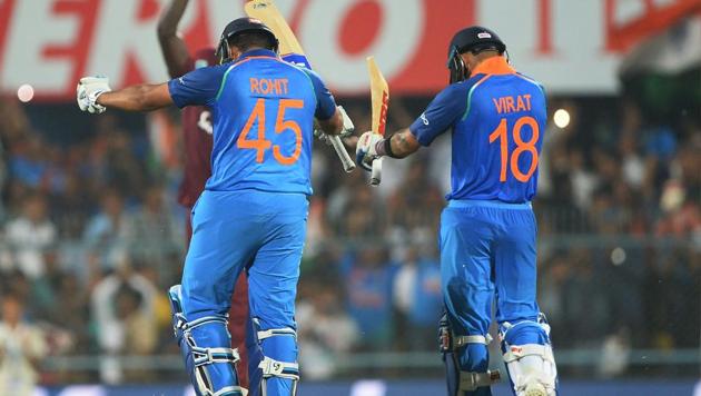 Indian batsman Rohit Sharma (L) celebrates with team captain Virat Kohli (R) after completing his century (100 runs) during the first one day international (ODI) cricket match between India and West Indies(AFP)