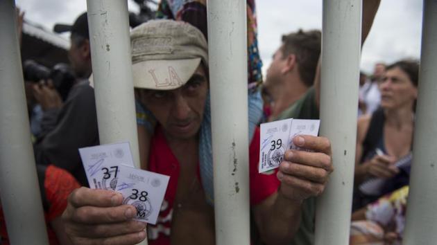 A Honduran migrant shows the tickets given by Mexican immigration authorities that enables him and his family to cross the border. Earlier in the day Trump renewed threats against Central American governments and blasted Democrats via Twitter for what he called “pathetic” immigration laws. In another tweet, he blamed Guatemala, Honduras and El Salvador for not stopping people from leaving their countries. (Oliver de Roos / AP) A Honduran migrant shows the tickets given by Mexican immigration authorities that enables him and his family to cross the border. Earlier in the day Trump renewed threats against Central American governments and blasted Democrats via Twitter for what he called “pathetic” immigration laws. In another tweet, he blamed Guatemala, Honduras and El Salvador for not stopping people from leaving their countries. (Oliver de Roos / AP)