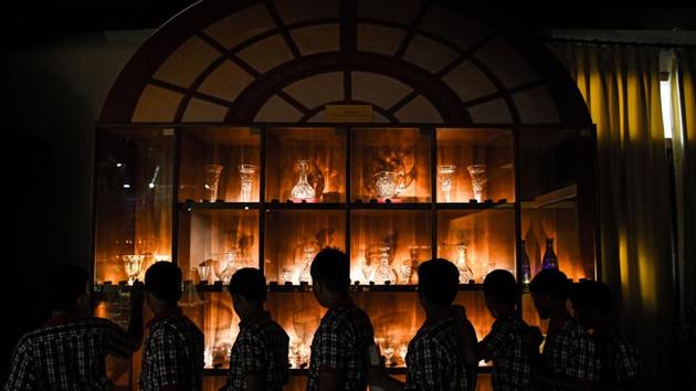 Students look at glassware used by former presidents of India. Storerooms not opened for decades -- some because of superstition -- were unlocked in a treasure hunt to put together the Rashtrapati Bhavan Museum’s collection. (Chandan Khanna / AFP) 
