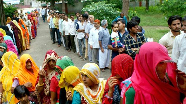 Voters waiting for their turn to exercise their franchise in the municipal corporation election at a poll booth in Jaipur’s Chomu area.(HT Photo)