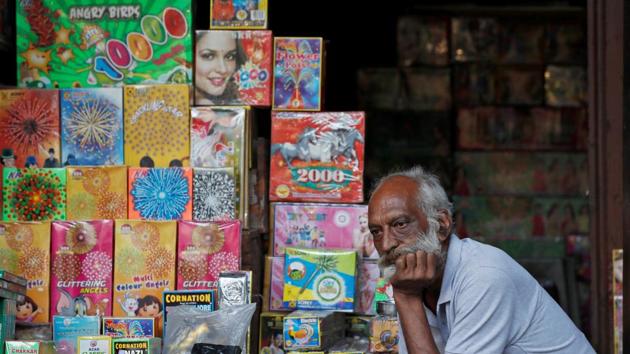 A shopkeeper waits for customers at his firecracker shop in Delhi. (REUTERS)