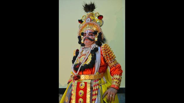 An actor in a king’s costume (raja vesha). Traditionally costume pieces have been made out of light wood wrapped in coloured foil, used mirrors and coloured stones while newer materials may be used now. Of note are the Yakshagana headgear, chestplates and armbands. Costumes use tones of red, orange and yellow in abundance. (Manjunath Kiran / AFP) An actor in a king’s costume (raja vesha). Traditionally costume pieces have been made out of light wood wrapped in coloured foil, used mirrors and coloured stones while newer materials may be used now. Of note are the Yakshagana headgear, chestplates and armbands. Costumes use tones of red, orange and yellow in abundance. (Manjunath Kiran / AFP)