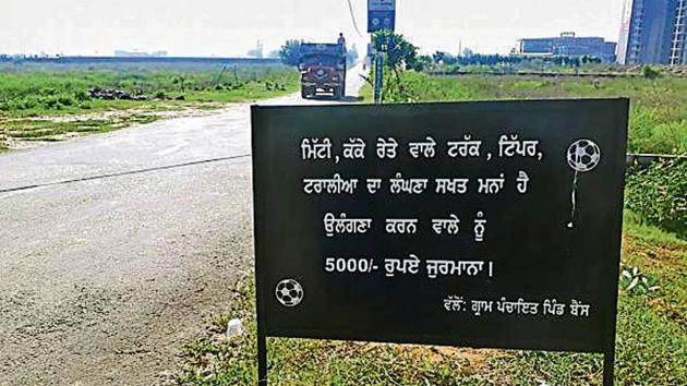 The board has been put up at the entry point of Bains village, 15km from Ludhiana.(HT Photo)