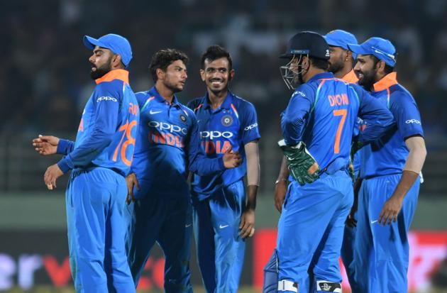 Indian cricket team captain Virat Kohli (L) and bowler Kuldeep Yadav (2L) celebrate with teammates after the dismissal of West Indies batsman Rovman Powell during the second one day international (ODI) cricket match between India and West Indies at the Dr. Y.S. Rajasekhara Reddy ACA-VDCA Cricket Stadium in Visakhapatnam. (AFP)