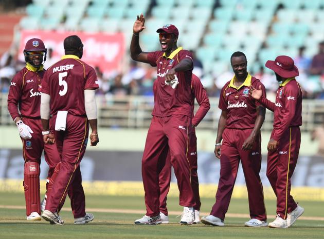 West Indies cricket captain Jason Holder (C) celebrates with his teammates for the dismissal of Indian cricketer Shikhar Dhawan during the second one day international (ODI) cricket match between India and West Indies at the Dr. Y.S. Rajasekhara Reddy ACA-VDCA Cricket Stadium in Visakhapatnam. (AFP)
