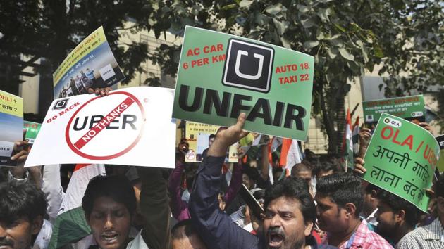 Drivers working for app-based taxis Uber and Ola protest outside Uber’s office in Mumbai on Monday.(AP)