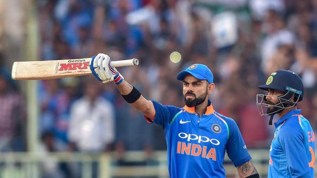 Virat Kohli raises his bat after completing 10,000 ODI runs during the second ODI match against West Indies.(PTI)