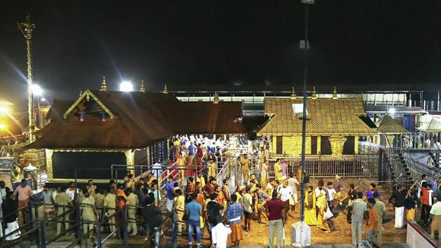 Devotees pay obeisance Lord Ayyappa temple in Sabarimala. (PTI) Devotees pay obeisance Lord Ayyappa temple in Sabarimala. (PTI)