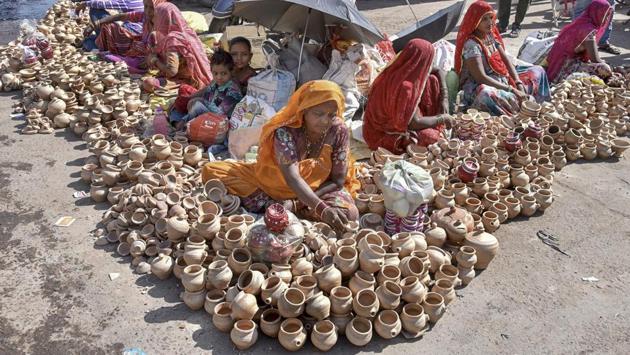Women sell traditional earthen pots for the upcoming Diwali festival in Bikaner. (PTI) Women sell traditional earthen pots for the upcoming Diwali festival in Bikaner. (PTI)