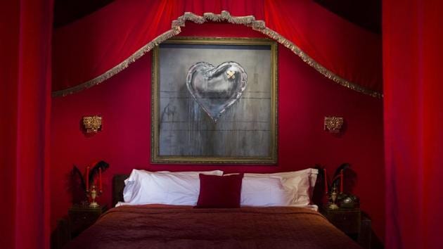 A heart-shaped balloon covered with bandages which is an iconic representation of the battle to survive a broken heart is seen inside a room at Walled Off Hotel. (Ilia Yefimovich / Getty Images)