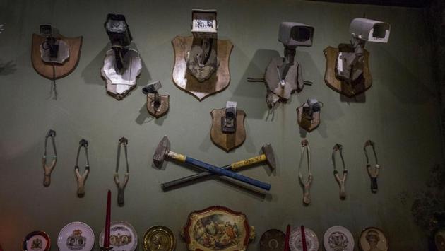 CCTVs mounted as hunting trophies, stare back at visitors passing through the art gallery at Banksy's Walled Off Hotel in the occupied West Bank town of Bethlehem. (Ilia Yefimovich / Getty Images)