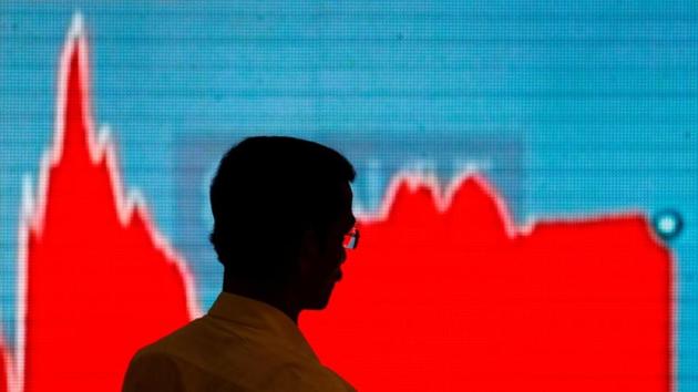 A man walks past a screen displaying news of markets update inside the Bombay Stock Exchange (BSE) building in Mumbai, India. (REUTERS) A man walks past a screen displaying news of markets update inside the Bombay Stock Exchange (BSE) building in Mumbai, India. (REUTERS)