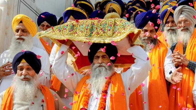 Sikh devotees take part in a 'Nagar Kirtan' procession at Sri Harmandir Sahib (Golden Temple) on the eve of the 484th birth anniversary of fourth Sikh Guru, Guru Ramdass Ji, in Amritsar. (PTI) Sikh devotees take part in a 'Nagar Kirtan' procession at Sri Harmandir Sahib (Golden Temple) on the eve of the 484th birth anniversary of fourth Sikh Guru, Guru Ramdass Ji, in Amritsar. (PTI)