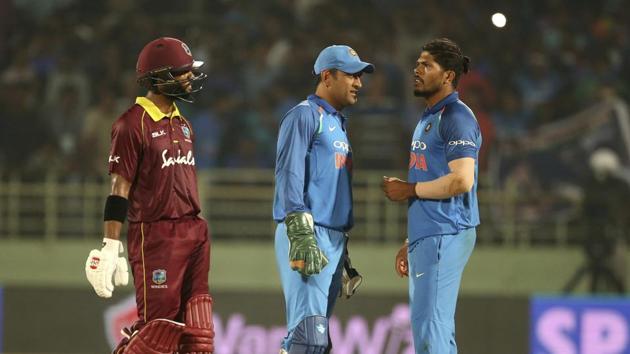 West Indies' Shai Hope, left, walks past India's Mahendra Singh Dhoni, center, and Umesh Yadav after the second one-day international cricket match between India and West Indies ended in tie.(AP)