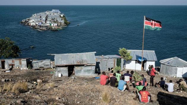 A Kenyan flag is seen at the base of Kenyan marine police on Usingo island overlooking Migingo. On the island, some taunt each other good-naturedly. “This is Kenya,” said Colins Ochyeng. “It’s Uganda,” fired back a Ugandan fisherman passing by, with a smile. “I don’t know who this island belongs to,” said Kenyan fisherman Emmanuel Aringo. “These are all political issues and we just want to sell our fish.” (Yashuyoshi Chiba / AFP)