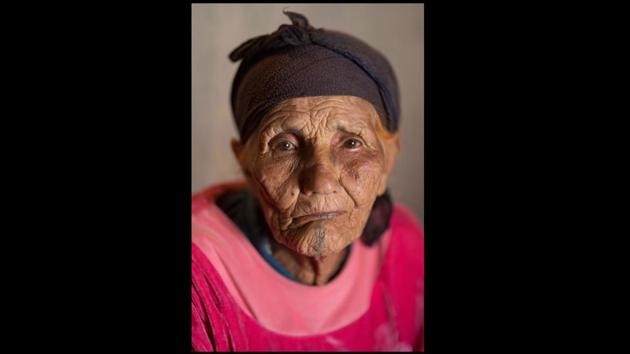 Fadma Olal, 100, poses for a portrait. Many Amazigh women consider their “ouchem” as feminine touches that set them apart from men and enhance their beauty.“Back then, I decorated my arms because I was wearing a Melhaf (traditional fabric), and we would pull it up so our arms could be seen. We did this when we were young; it was a sign of beauty,” said Olal. (Mosa'ab Elshamy / AP)