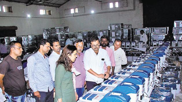 Deputy election officer Monika Singh (in green colour dress) at the administrative godown in Bhosari during the inspection of electronic voting machines, which were brought to Pune in the beginning of October.(HT Photo)