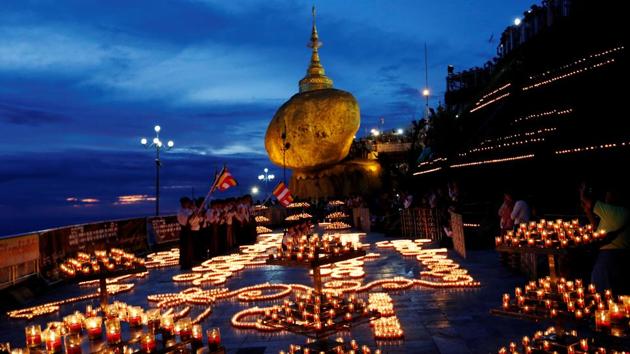 Buddhist pilgrims light candles around the Golden Rock or Kyaikhtiyo Pagoda to celebrate the full moon festival in Kyaikto, Mon state, Myanmar. (Ann Wang / REUTERS) Buddhist pilgrims light candles around the Golden Rock or Kyaikhtiyo Pagoda to celebrate the full moon festival in Kyaikto, Mon state, Myanmar. (Ann Wang / REUTERS)