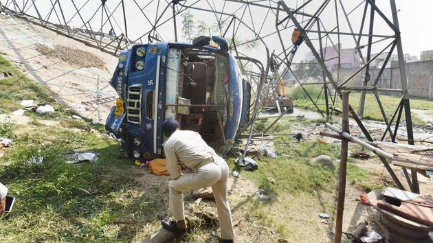 Patna: A police offical inspects at the accident site where a bus collided with an electric tower near Dhanki More, in Patna, Friday(PTI)