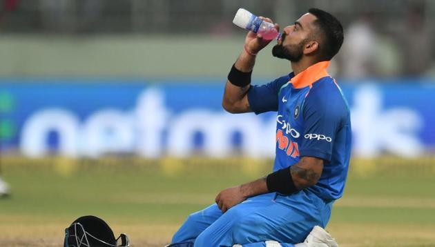 Indian cricket captain Virat Kohli drinks during the second one day international (ODI) cricket match between India and West Indies(AFP)