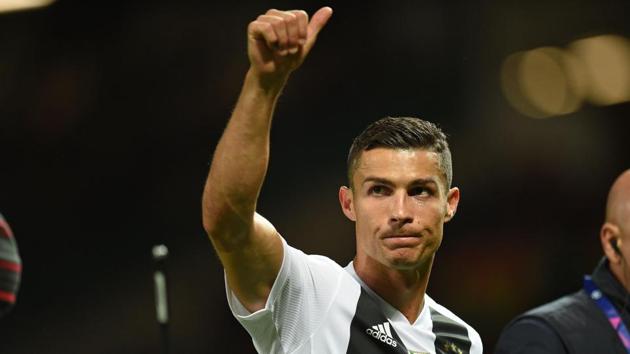 Juventus' Portuguese striker Cristiano Ronaldo gestures to supporters on the pitch after the Champions League group H football match between Manchester United and Juventus at Old Trafford in Manchester(AFP)