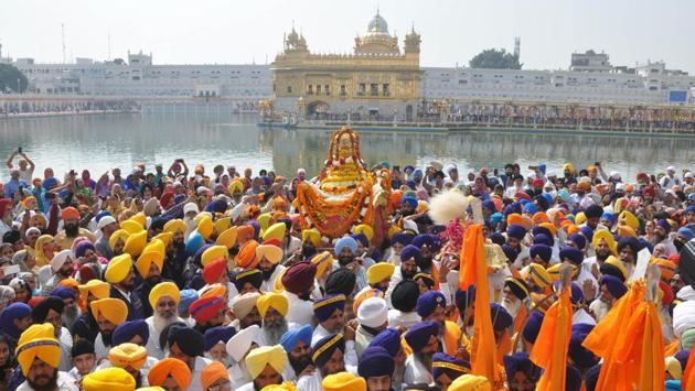 Devotees carry Sri Guru Granth Sahib Ji during a religious procession at the Golden Temple in Amritsar. (Sameer Sehgal/HT)